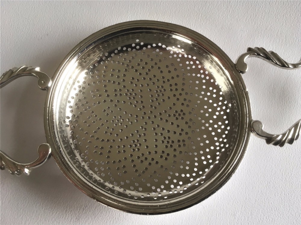A fabulous silver lemon strainer View IV