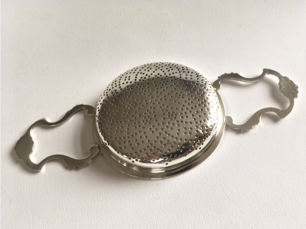 A fabulous silver lemon strainer View VI