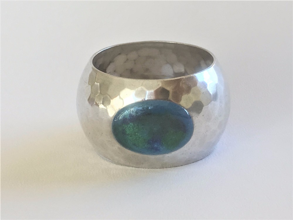 A fabulous Arts & Crafts silver & enamel napkin ring