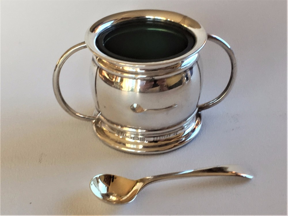 A stylish silver cruet with green liners and spoons View III