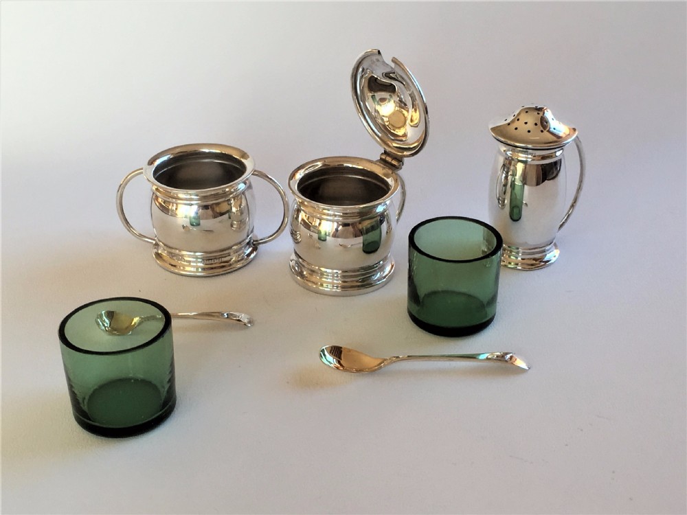 A stylish silver cruet with green liners and spoons View VII