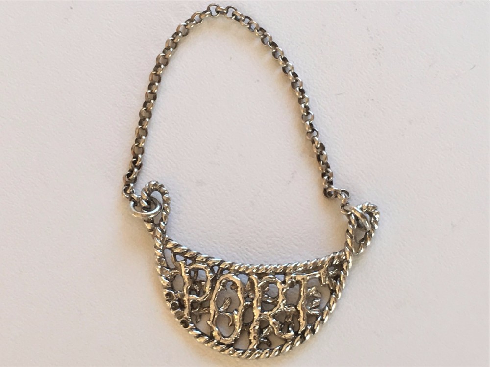 An unusual cast Victorian silver Port label
