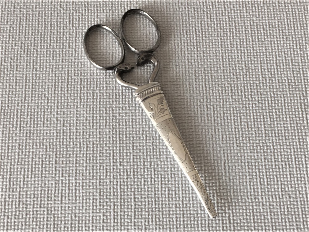 A pair of Georgian silver cased sewing scissors