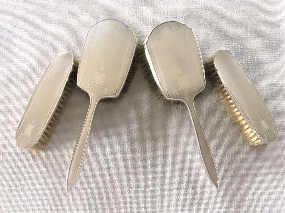 A set of four Art Deco silver brushes