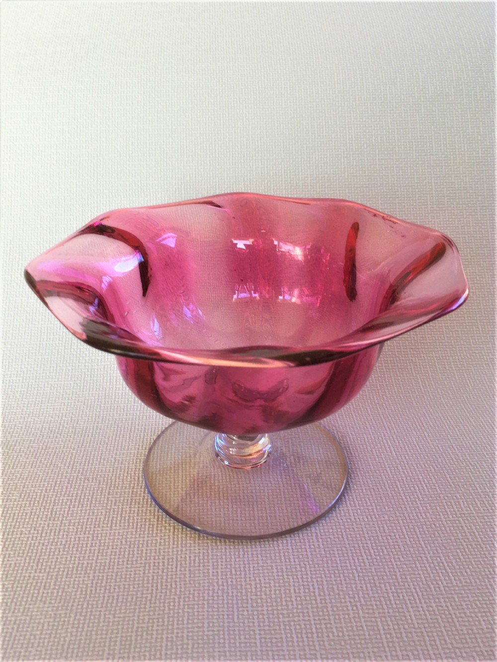 A Victorian cranberry wrythen pedestal bowl