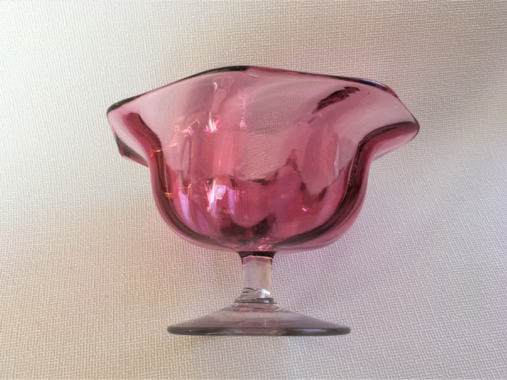 A Victorian cranberry wrythen pedestal bowl View V