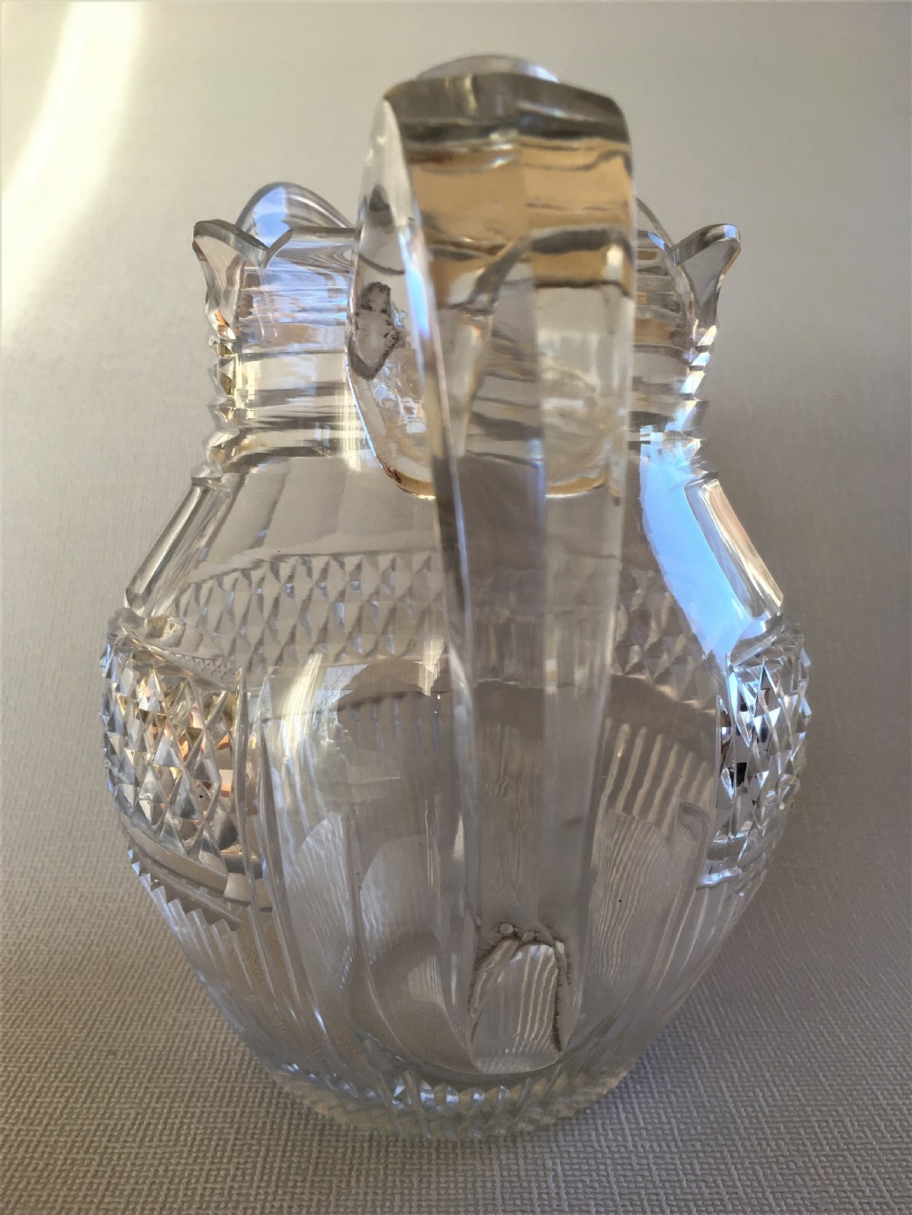 A handsome Regency cut glass water jug View IX