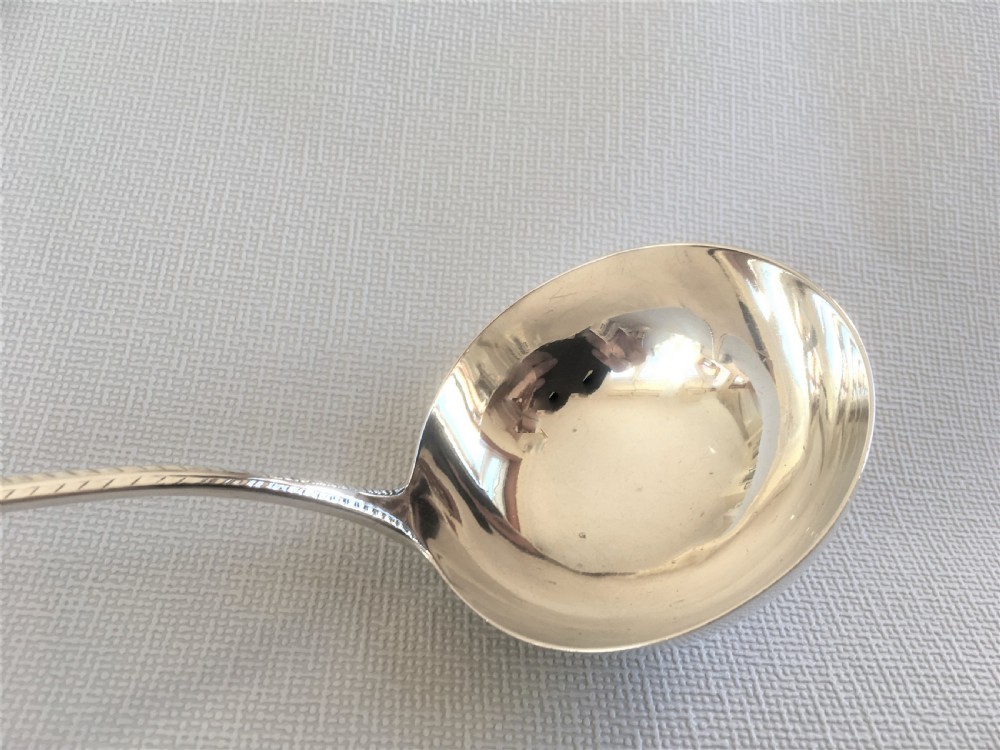 An 18th Century small silver soup ladle View II