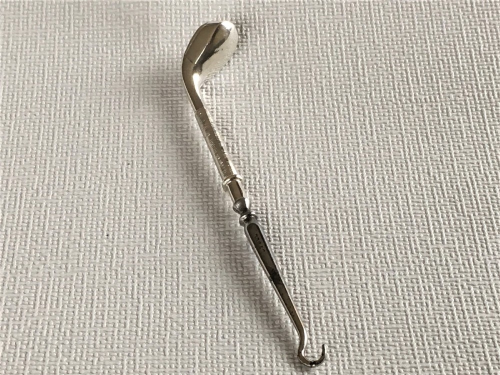 A rare silver golf club button hook View VII