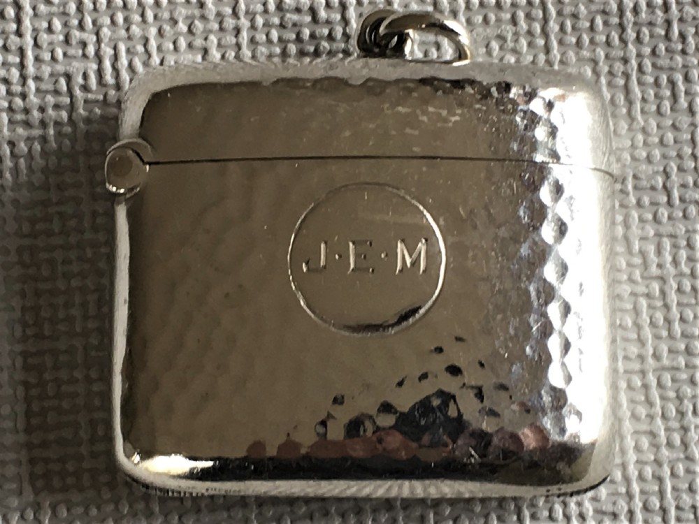 An Arts & Crafts hammered Edwardian silver vesta