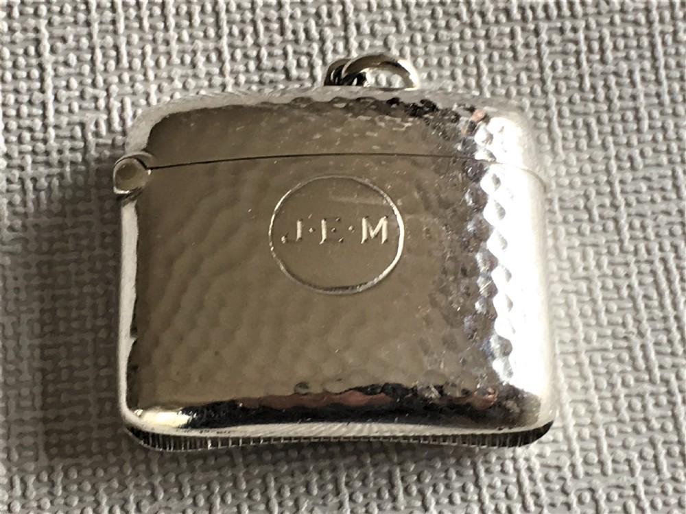 An Arts & Crafts hammered Edwardian silver vesta View II