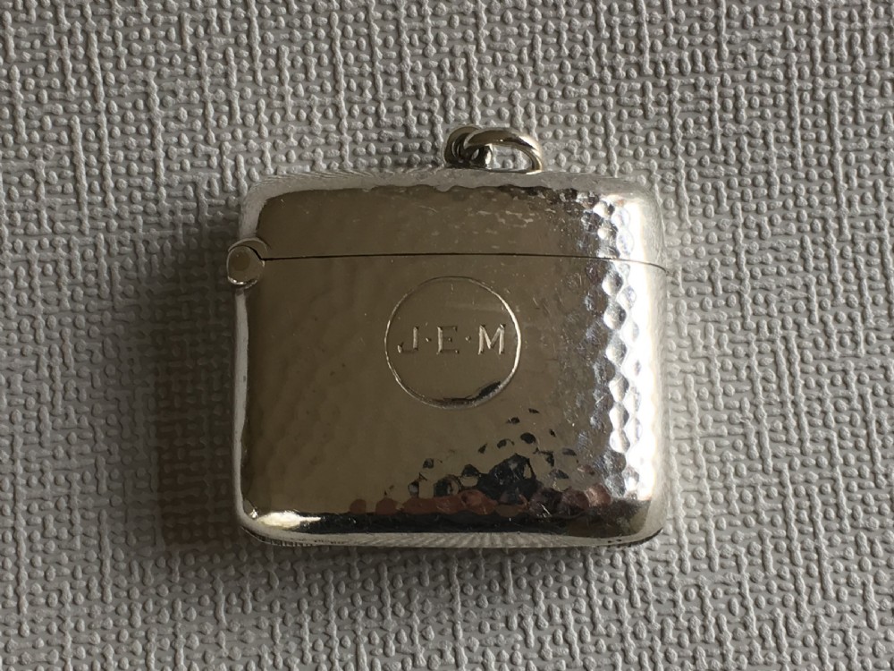 An Arts & Crafts hammered Edwardian silver vesta View IV