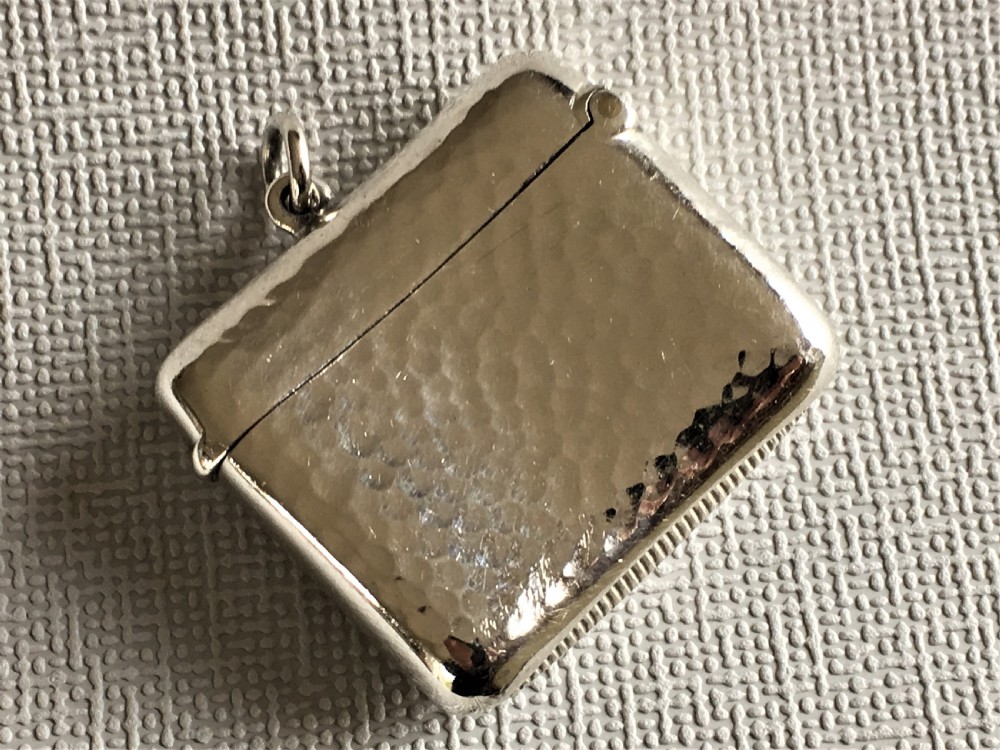 An Arts & Crafts hammered Edwardian silver vesta View V