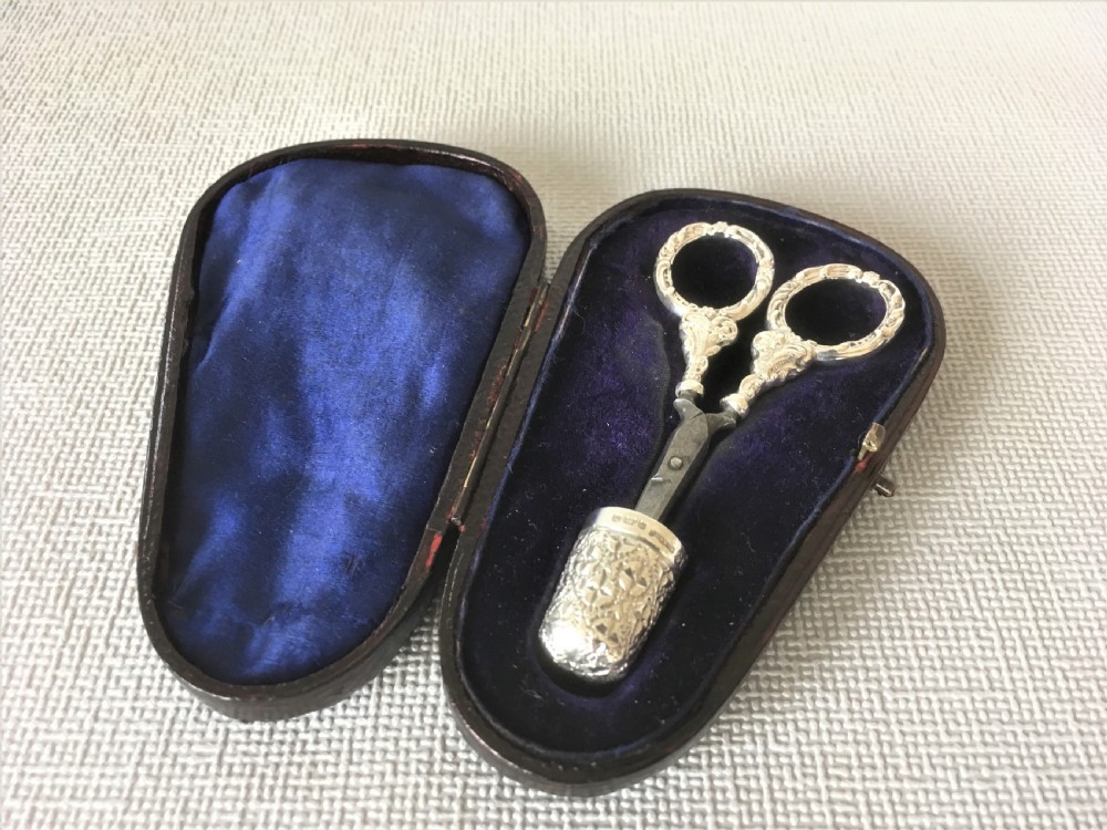A cased pair of Victorian silver sewing scissors & thimble View II
