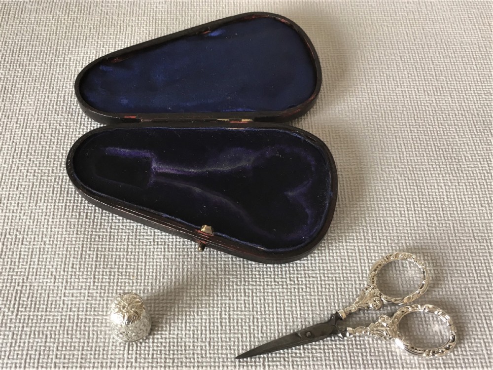 A cased pair of Victorian silver sewing scissors & thimble View IV