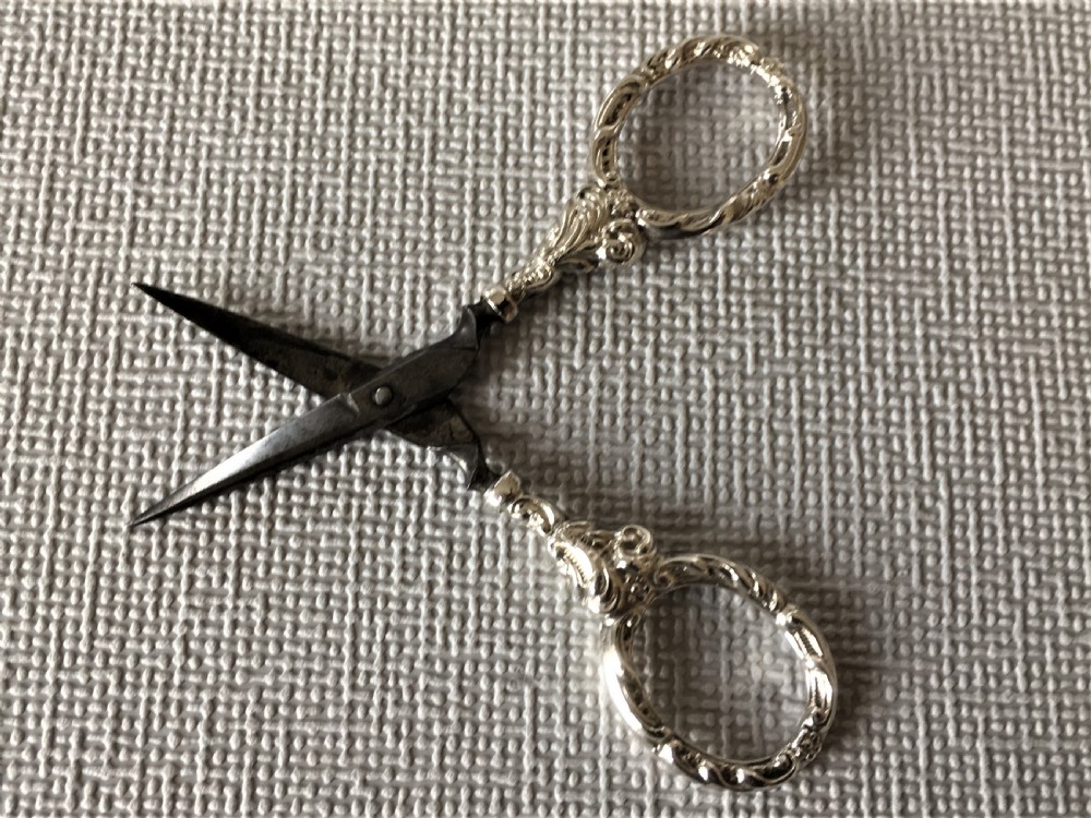 A cased pair of Victorian silver sewing scissors & thimble View V