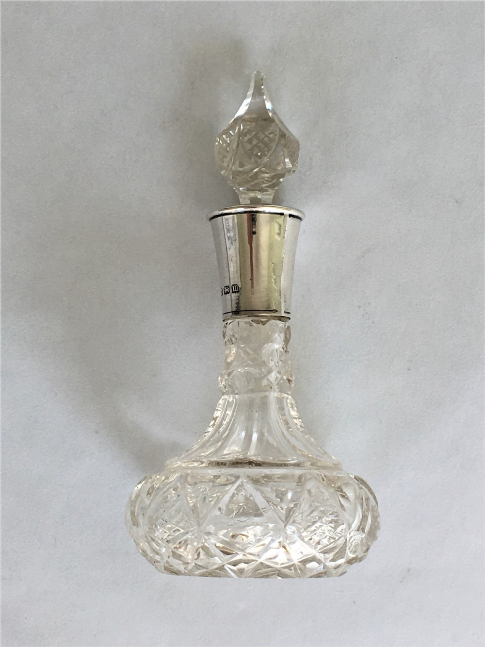 A small George V silver mounted scent bottle