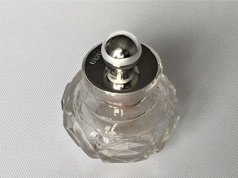 A pretty silver mounted cut glass scent bottle