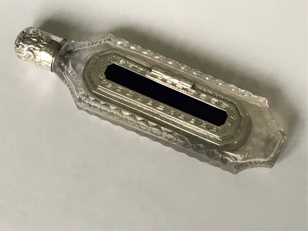 An unusual Victorian silver scent flask with memento compartment