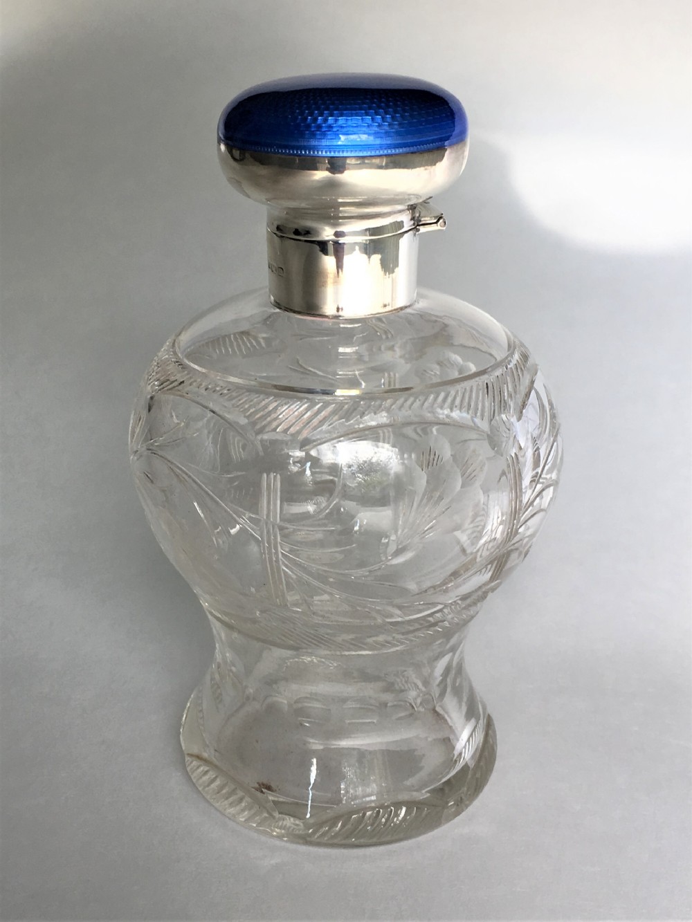 A fabulous silver & guilloche enamel cologne bottle