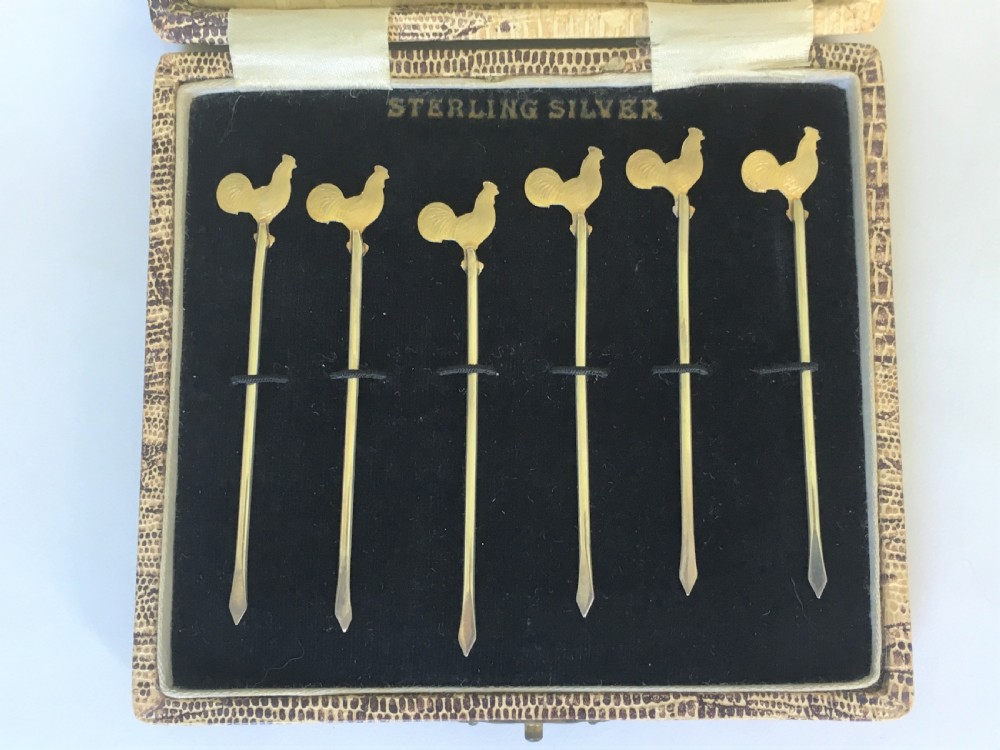 A set of silver gilt cockerel cocktail sticks