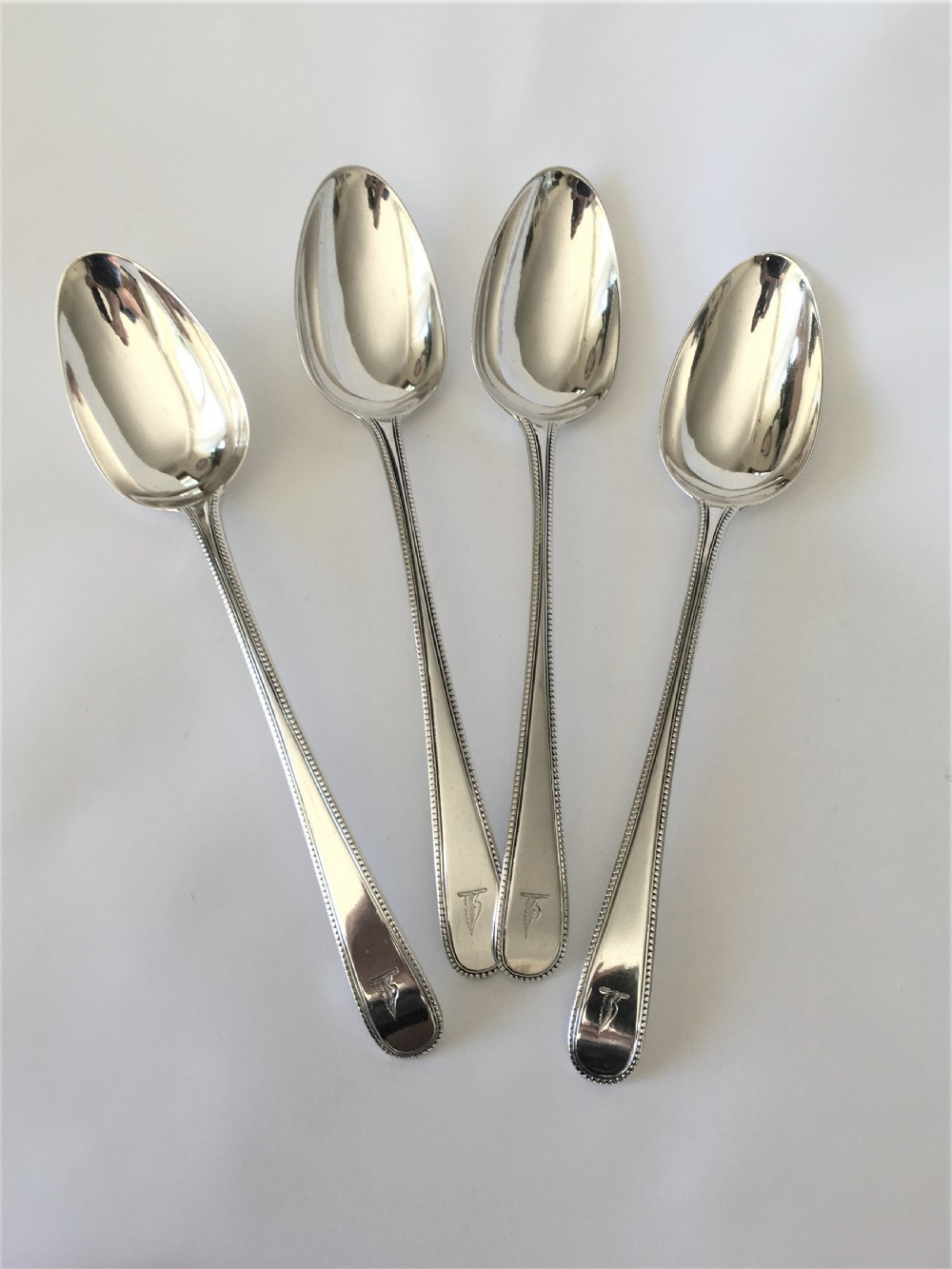 A rare set of 4 Eighteenth Century silver serving spoons