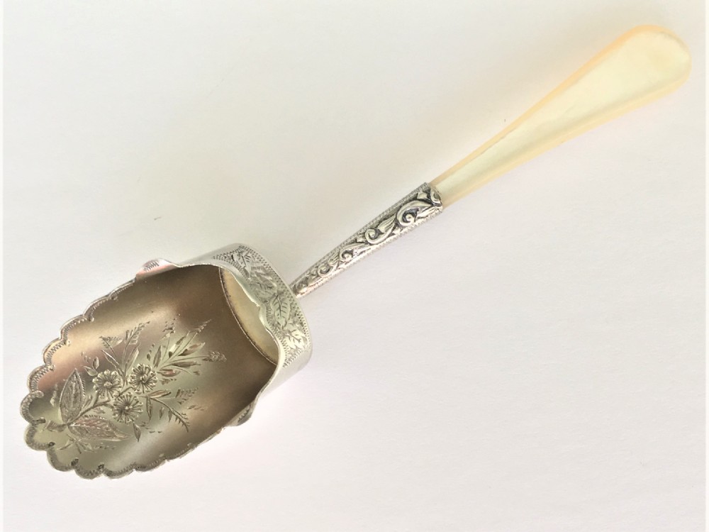 A pretty Victorian silver gilt caddy shovel