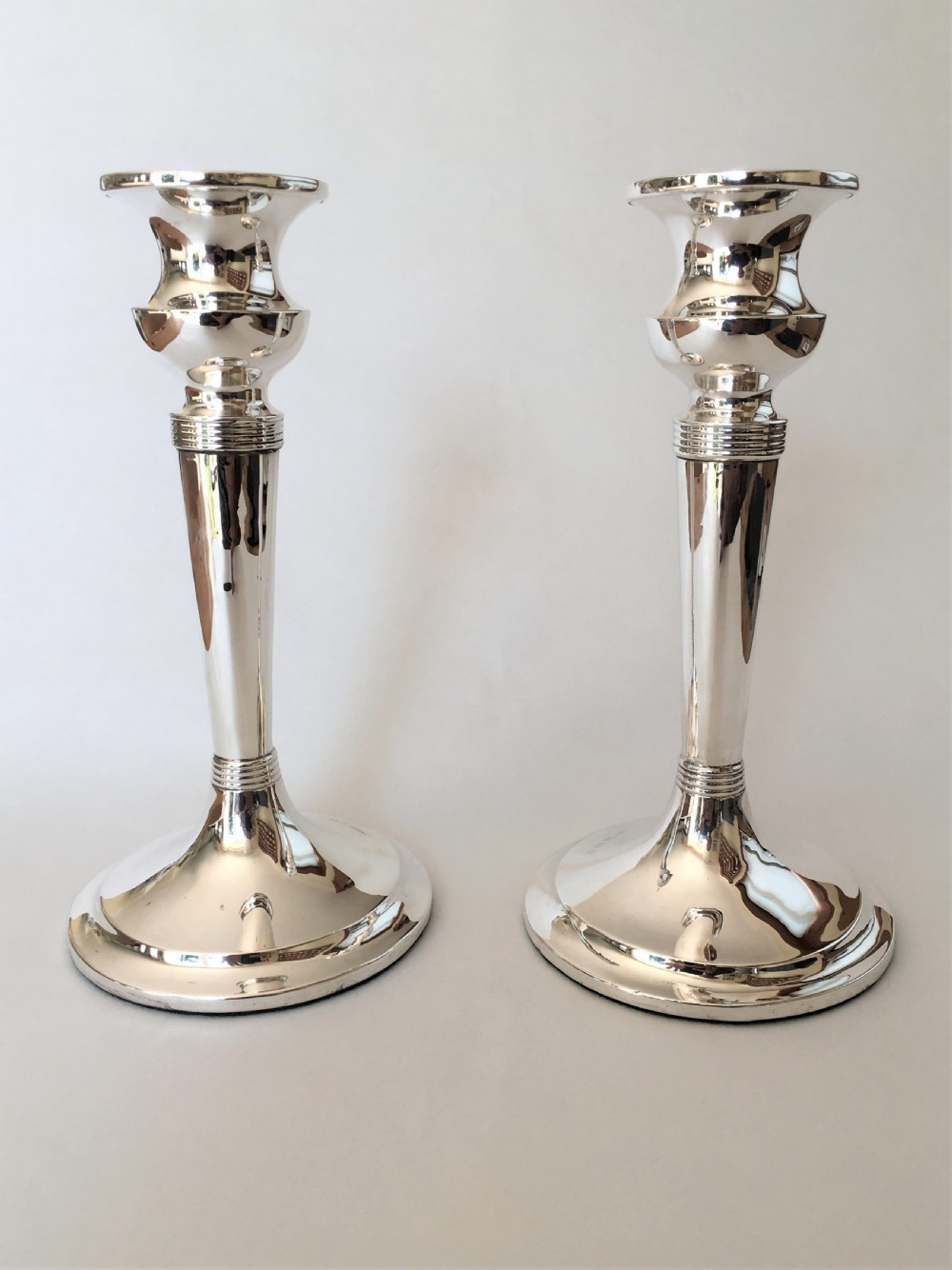 A handsome pair of Edwardian silver candlesticks