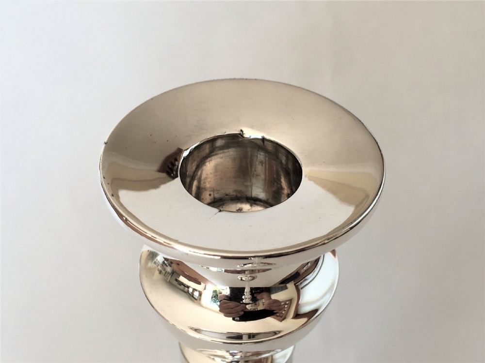 A handsome pair of Edwardian silver candlesticks View V