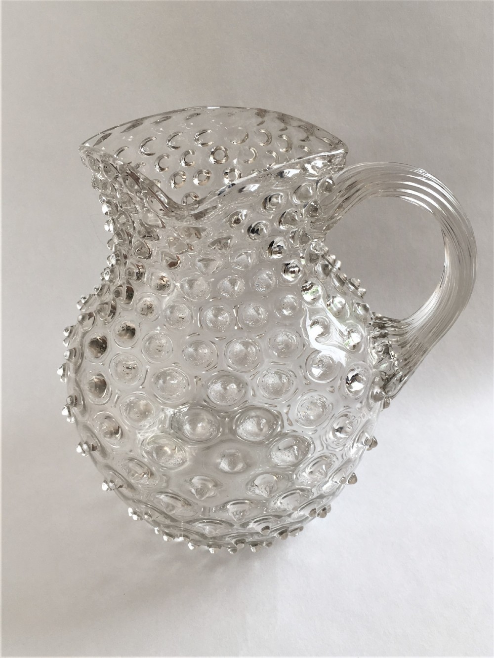 An impressive Victorian 'bobbled' glass water jug