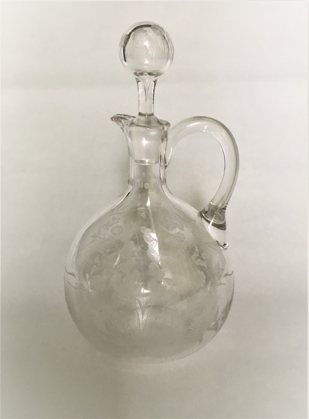 A Victorian flower and fern etched wine jug