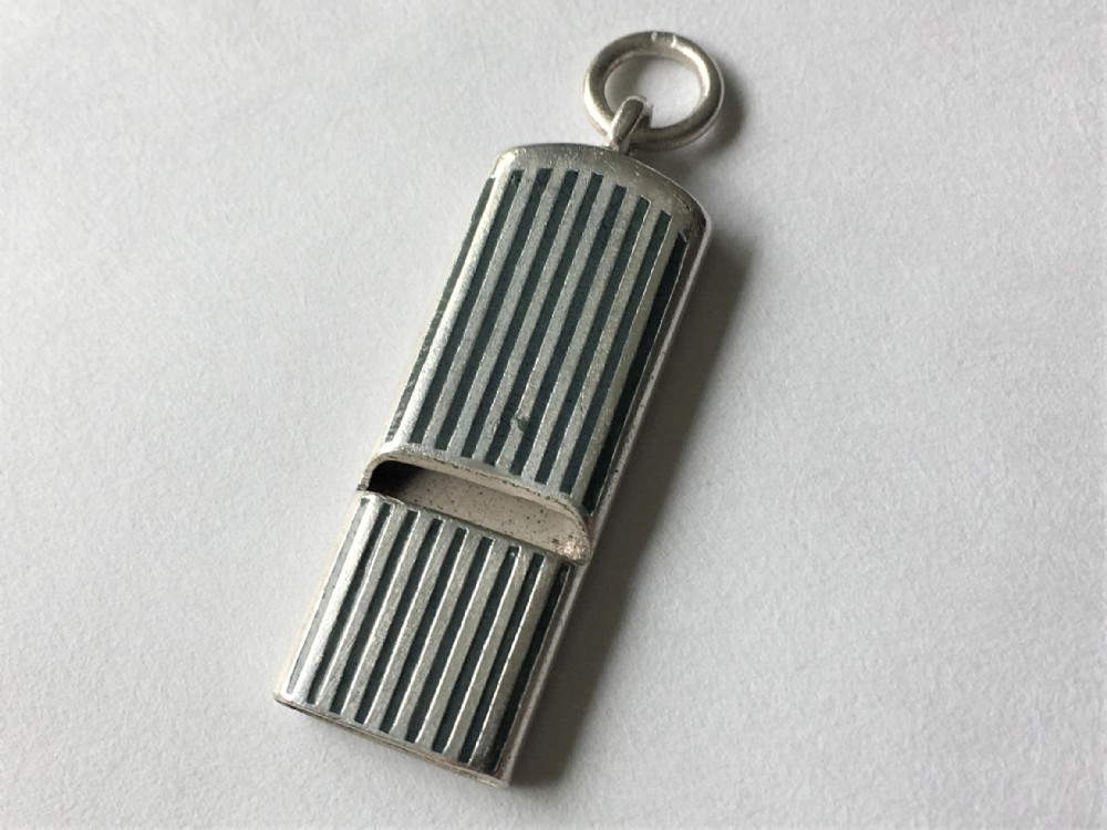 A rare silver and enamel whistle