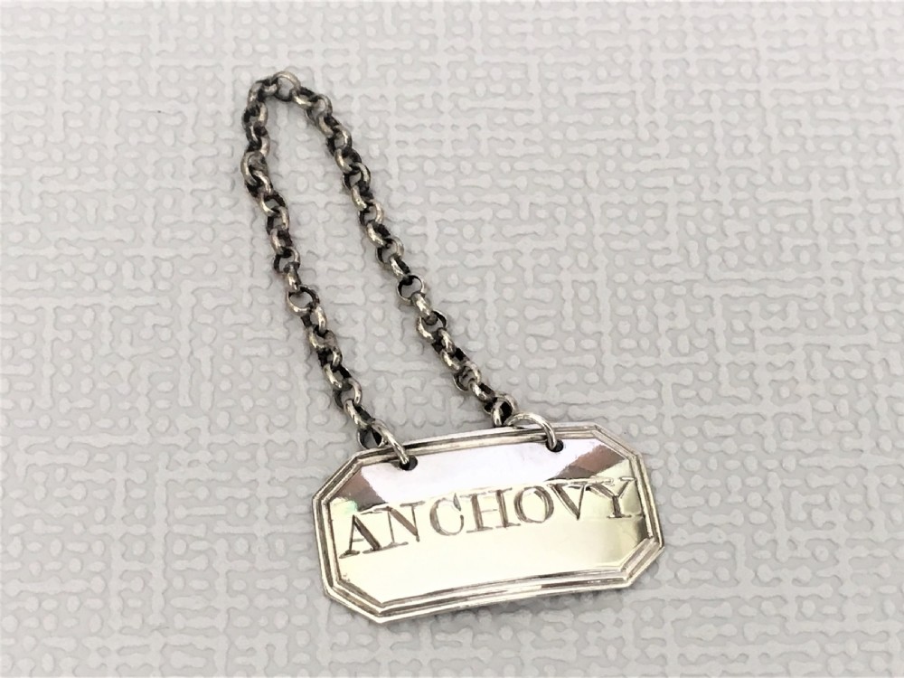 An 18th Century silver 'anchovy' label