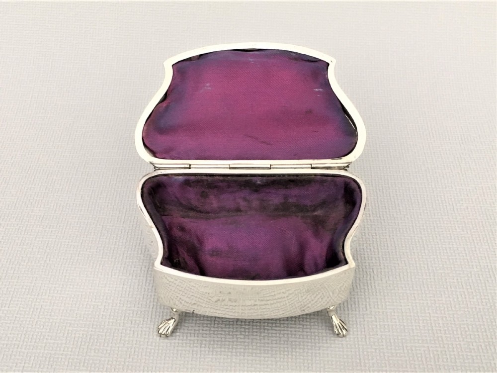 A shaped silver trinket box with engraved decoration View V