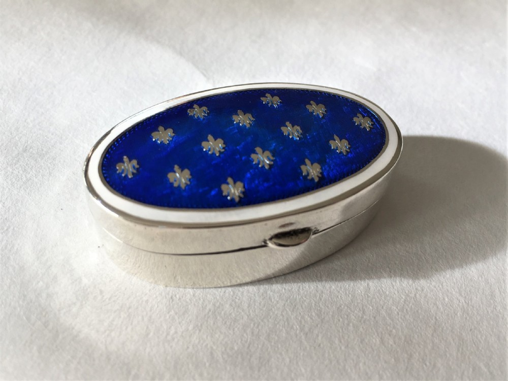 A fabulous silver & bi-coloured enamel pill box