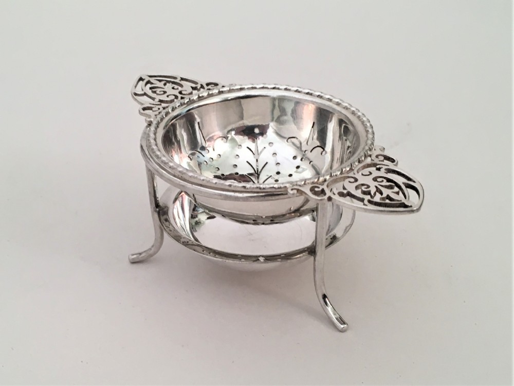 A charming silver tea strainer & drip cup