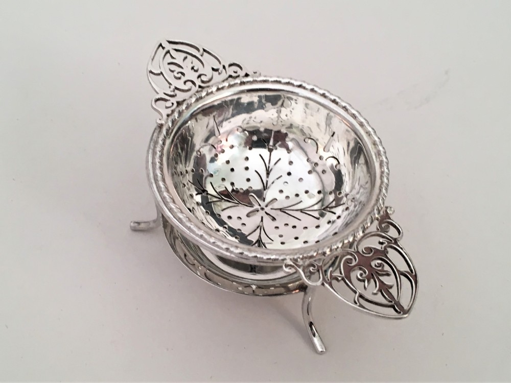 A charming silver tea strainer & drip cup View II