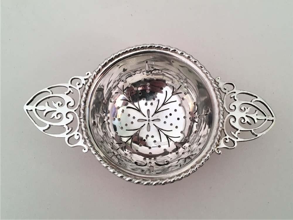 A charming silver tea strainer & drip cup View III