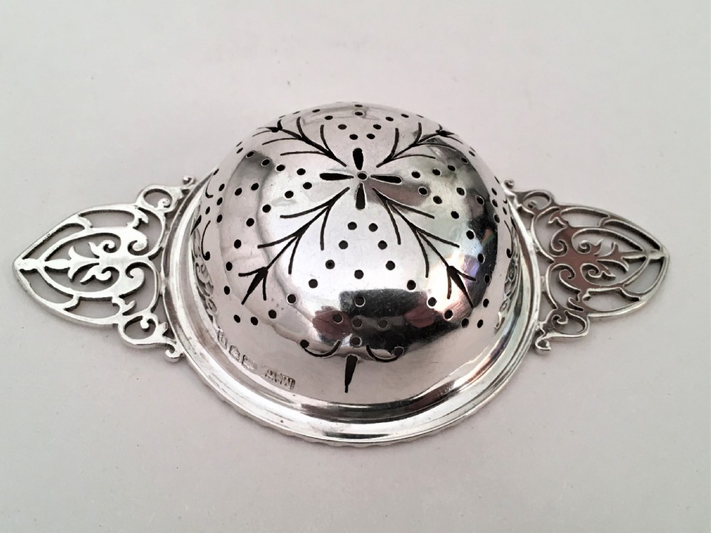 A charming silver tea strainer & drip cup View IV