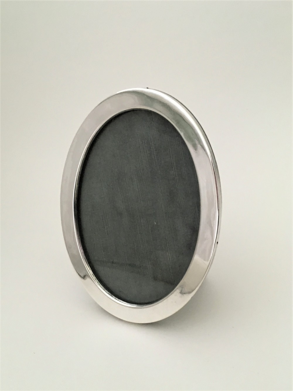 A handsome oval silver photo frame