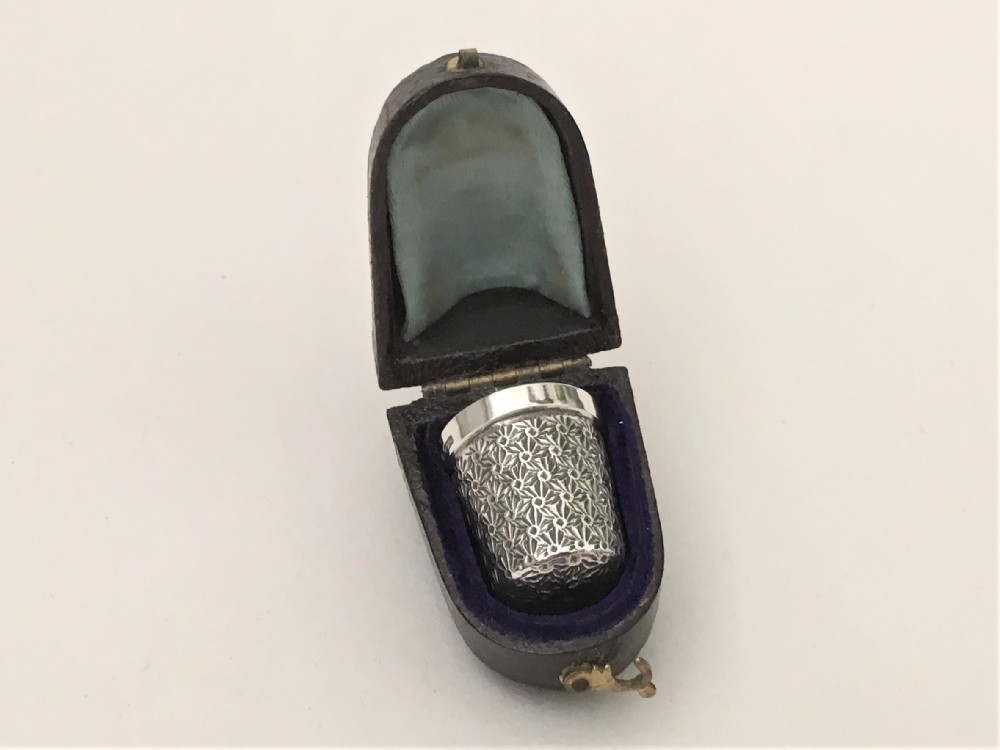 A charming cased silver thimble