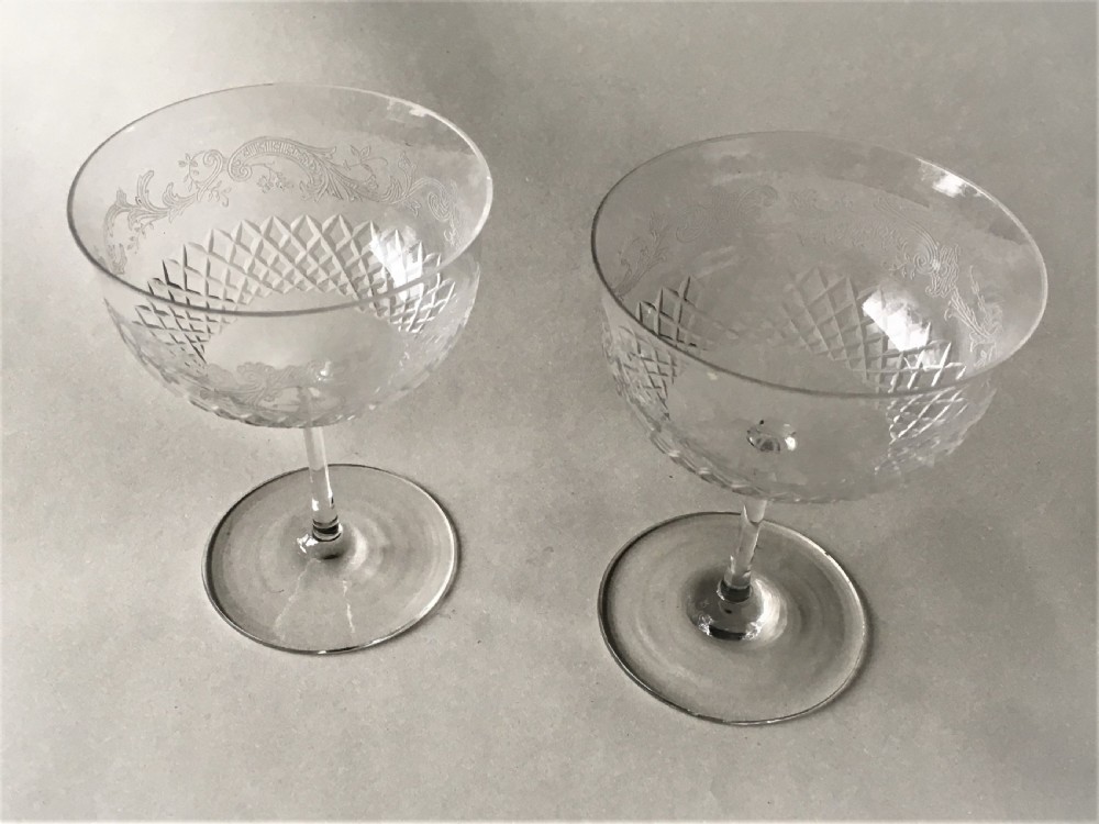 A charming pair of etched Edwardian champagne glasses