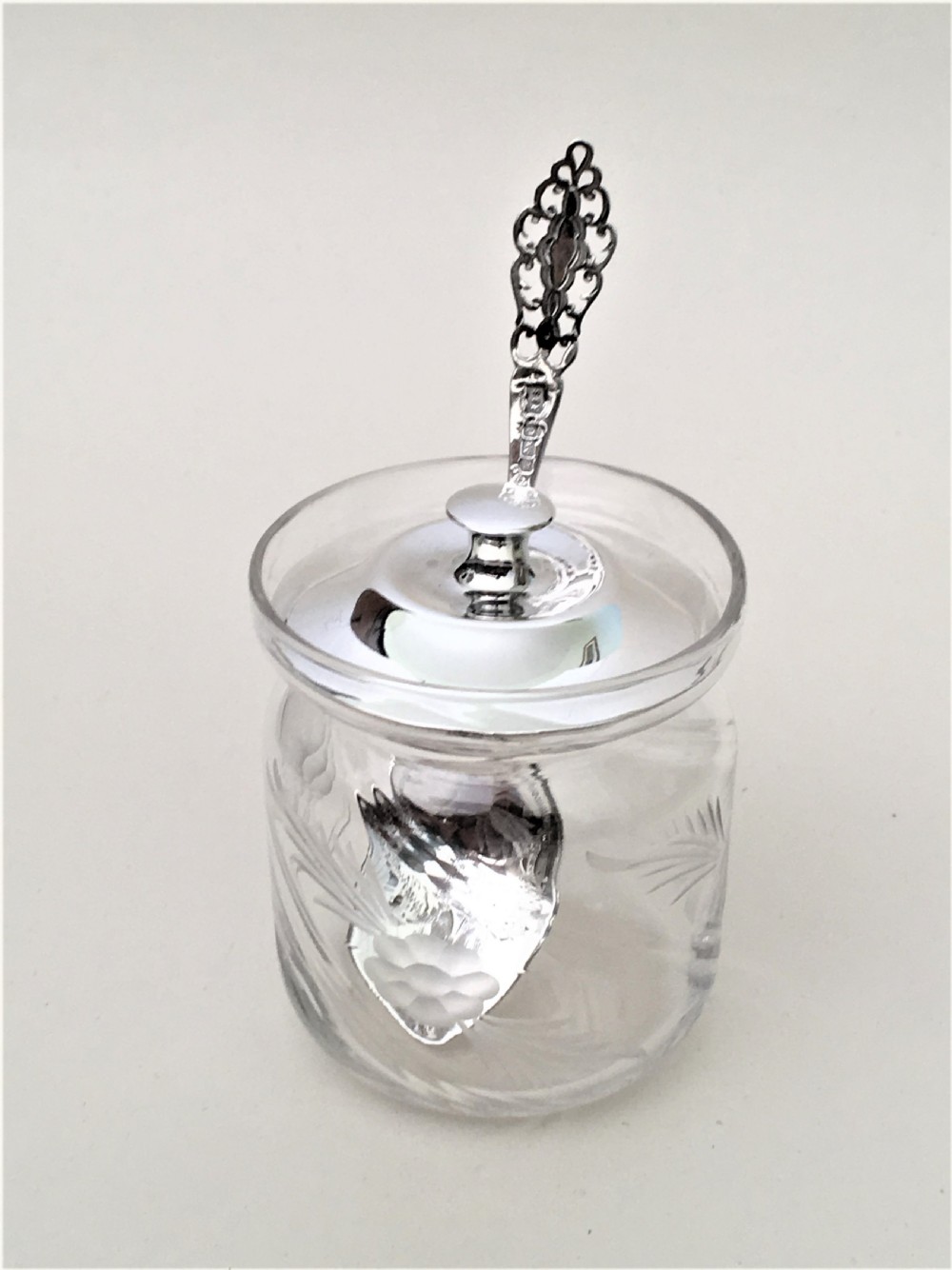 A delightful Edwardian silver mounted preserve jar and spoon