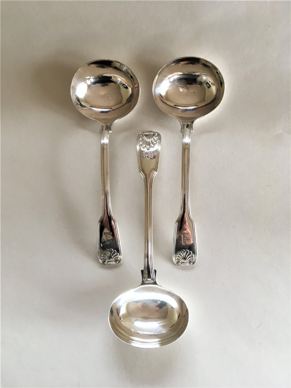 Three Georgian silver gravy/sauce ladles