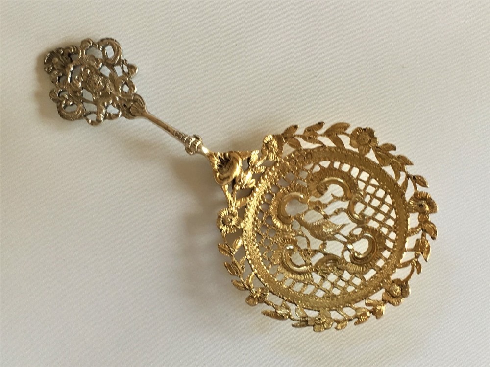 A fabulous William Comyns pierced silver gilt bonbon spoon