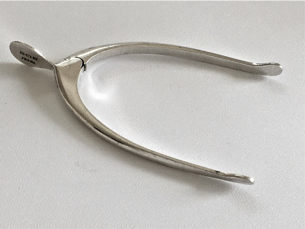 A pair of novelty silver sprung wishbone tongs