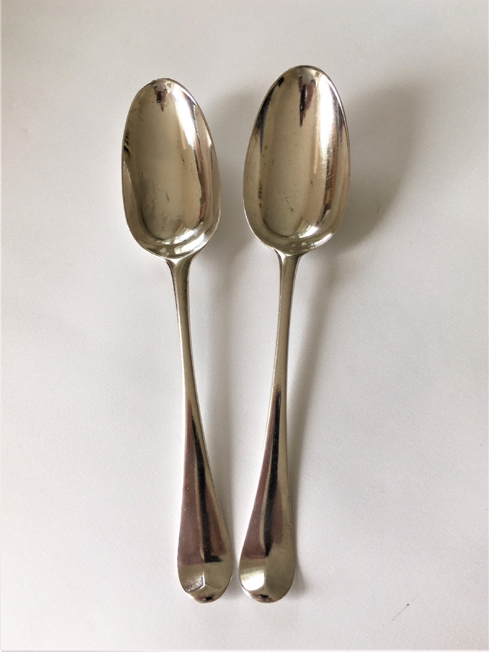 A fabulous pair of mid 18th Century silver serving spoons