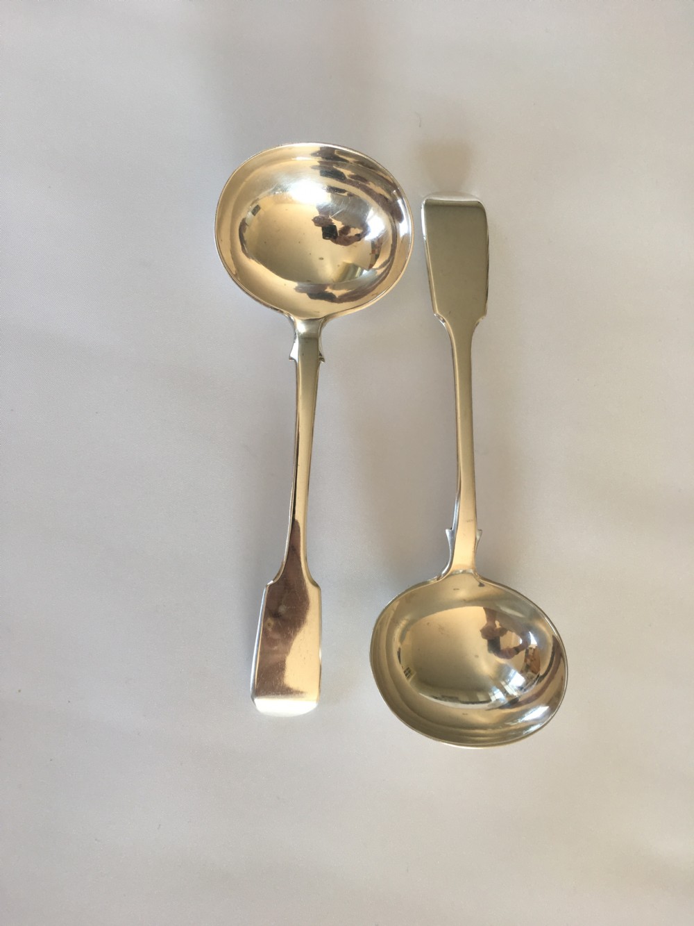 A fine pair of Victorian silver gravy ladles