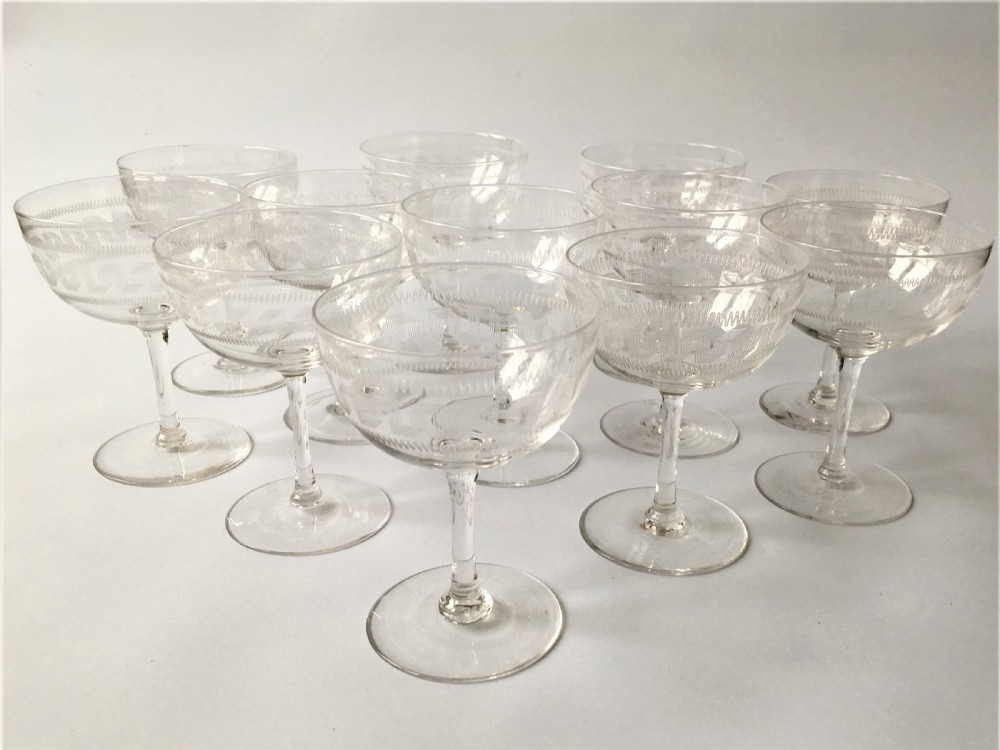 A fine set of 12 Greek Key etched champagne bowls