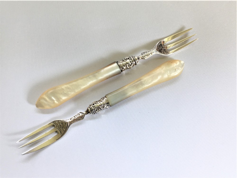 A gorgeous pair of Victorian silver pickle forks
